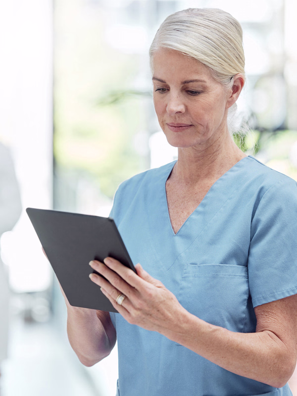 Pflegerin lernt auf Tablet